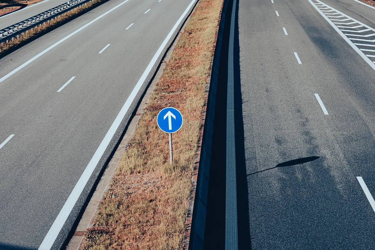 road, highway, roadway, traffic sign, street sign, signpost, highway, highway, roadway, roadway, roadway, roadway, roadway
