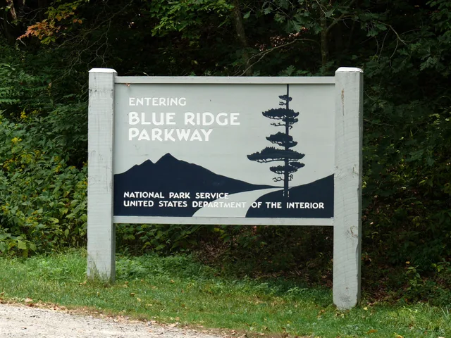 Welcome sign at the southern terminus of the Blue Ridge Parkway . Located near the town of Cherokee and the Great Smoky Mountains National Park . Credits Photo taken with a Panasonic Lumix DMC-FZ50 in Swain County, NC, USA. Blue Ridge Parkway signs compared with US Route 66 markers